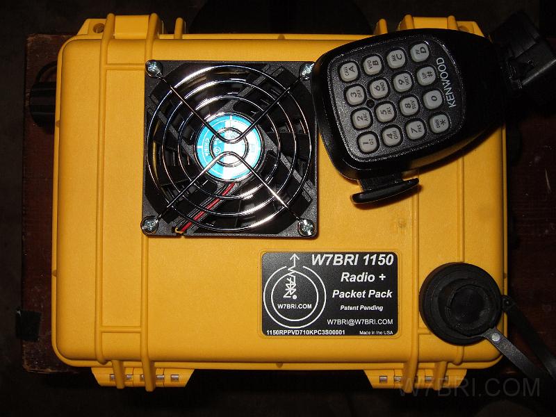 1150 Radio + Packet Pack.jpg - Here's an external shot of the    Pelican 1150 case    that houses the Kenwood D710A radio, Kantronics KPC3 Plus modem, bluetooth GPS, etc..  Click on the thumbnail to see a bigger picture.  The case is only 9.12" x 7.56" x 4.37"; it's small and light enough to take pretty much anywhere without getting in the way or feeling like a boat anchor.  I made the label with Adobe Illustrator and paid    Delp's Awards    in Eugene to laser engrave them for me.  They do great work, and only charged $3 for each label.