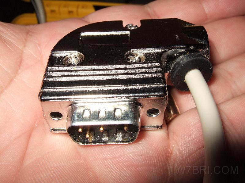 Modified KPC3 to Kenwood adapter.jpg - This    right-angle metal D-sub hood kit    was a great addition to my new    Radio / Packet Pack     because it works in very tight spaces. This pic shows the adapter that connects my    Kantronics KPC-3+'s    DB9 radio jack to my    Kenwood D710A's    DIN6 port. I drilled a hole in the adapter and installed a rubber grommet so I could route the cable 180 degrees to the other side of the case. 