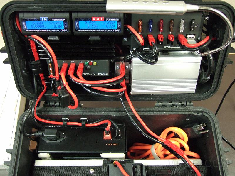 Top & bottom close up - V2.jpg - To the casual eye, not much has changed from the original design.  It uses the same PWRgate, inverter and power supply (wires visible at the bottom of the image) and batteries (not shown; Hawker Odyssey PC680s as an option).  The Red-Dee PS-4 PowerPole splitter has been re-modified with sturdier "meltable wall" shrink tube and secured with a plastic clamp.  The PVC-coated power cables have all been replaced with superior 200C/400F silicone-coated cable.  I decided to swap out the RIGrunner 4005 for the 4004U version.  Although it has one less PowerPole jack, I actually gained a free PP jack because I ditched the thermometer (which required a 12V -> 5V adapter) and the LED strip (needed a PP jack).  I now use a much brighter flexible    USB LED light   . In the middle of the lid (between the PWRgate and silver inverter), I added a PowerPole pedestal that connects the PWRgate to wires behind the back plate that run to the new backlit Turnigy meters.  One of the meters connects to the battery via the two holes at the bottom of the pedestal (cords are hanging down).  Why did I install two meters?  Well, I discovered that the reasonably-priced meters that would fit in my case all had the same limitation: Although they will pass current, etc. from the load to the source (right to left) side of the meter, they will NOT display it. Anyhow, this "flaw" is a problem when you have a bidirectional power system and need to simultaneously view the charge (in) and discharge (out).  Sure, you could swap cables with one meter like an old-timey switch board operator (and lose all of your stored data in the process), but I wanted to make something better that didn't require guesswork or an instruction book.  As for how I wired the meters, it's difficult to explain, but here goes (see the cheesy MS Paint diagram, below):  Let's call the incoming meter "IN" and the outgoing meter "OUT".  Both have "source" and "load" cables; "IN/S", "IN/L", "OUT/S" and "OUT/L".  The PWRgate charger has "PS", "OUT" and "BAT" jacks; "PG/PS", "PG/OUT", "PG/BAT".  The jacks on the PowerPole pedestal between the PWRgate and inverter that PG/OUT and PG/BAT connects to are called "PP/OUT/FRONT", "PP/OUT/BACK", "PP/BAT/FRONT" and "PP/BAT/BACK".  Here's how they connect: AC/DC in -> PS4 splitter -> PG/PS -> PG/OUT and PG/BAT; PG/OUT -> PP/OUT/FRONT -> PP/OUT/BACK -> OUT/S -> OUT/L -> RIGrunner (RR)-> load/DC OUT. PG/BAT -> PP/BAT/FRONT -> PP/BAT/BACK -> IN/S -> IN/L -> BATTERY.  When no external AC/DC is present, the battery takes over: BATTERY -> IN/L -> IN/S -> PP/BAT/BACK -> PP/BAT/FRONT -> PG/BAT -> PG/OUT -> PP/OUT/FRONT -> PP/OUT/BACK -> OUT/S -> OUT/L -> RR -> DC OUT.  That's about a dozen steps, but it all seems to flow efficiently.  I think Rube Goldberg would've liked it.  :-)