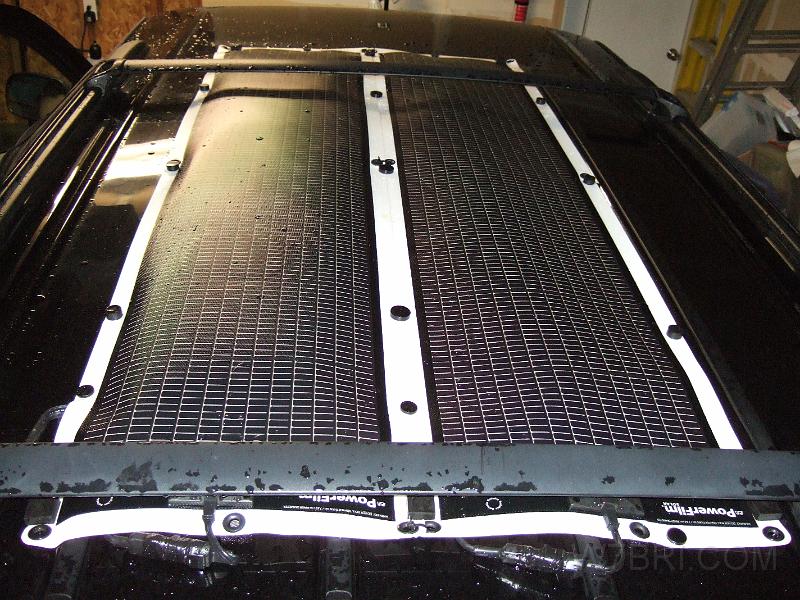 Solar SUV #1.JPG - I've built versatile battery packs for years, so I figured it was time to investigate alternate ways of charging them.  Living in Oregon, I was very skeptical at first that a solar panel would be any good -- especially in winter.  After more consideration, I decided that I was thinking about it the wrong way. Solar shouldn't be dismissed just because it may be less efficient and more expensive than conventional sources of power.  Unfortunately, many people assume that they will always be able to plug into a wall socket somewhere.  Good luck with that when the power goes out during an emergency, or if you simply want to go camping off the beaten trail. As I mentioned in my    1150 Radio + Packet Pack    project, having more options, especially in a disaster, is always better...  Solar is just another tool in your toolbox; another way to get power if other options are not available.  It is NOT able to replace all the power you likely use every day at home, but it can be enough to help you stay alive until you find AC power again.  It can also be used in small every day applications.  Just don't expect it to run your hair dryer.   When looking for solar panels, I made a laundry list of several must-have features: 1) The panels had to be light; 2) they had to be flexible; 3) they had to be waterproof; 4) they had to work in low / poor light; 5) they had to be easily "paralleleled" to allow more current.  The ones made by    PowerFilm    fit the bill, and then some.  They are amazingly durable.  Check out    this video    and see for yourself.  I was so impressed by their panels, I became a PowerFilm dealer so I could get a better price on them. The picture above shows two 21 watt rollable panels wired in parallel (42W total) on the top of my truck, held down by super strong    neodymium magnets   .  They've been up there since December 2010 without any problems.  During peak sun, I should be able to squeeze about 2.7 amps of current out of them to charge my battery packs.  They weigh only 1.42lbs each, and are 60.75 x 14.5 inches (~60.75 x 28 inches for the two shown).    Other than buying them from me, the lowest price you'll find these 21W panels is $270 each.  Look around, then come back here.  As a dealer, I must order six at a time in order to receive a discount -- so, I can't afford to accept orders from customers who want to buy only one of them.  If you're willing to order two or more, I can sell them to you for $240 apiece.  I rarely keep stock on hand that isn't already earmarked for a customer, so orders might take a couple weeks to fill.  Please e-mail me before placing one.  $495  (two 21W rollable solar panels, plus one paralleling cable; also includes 15ft extension cable with ring terminals and DC socket adapter) 